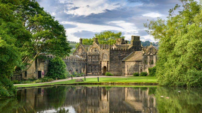The exterior of East Riddlesden Hall, West Yorkshire, with the pond in the foreground.